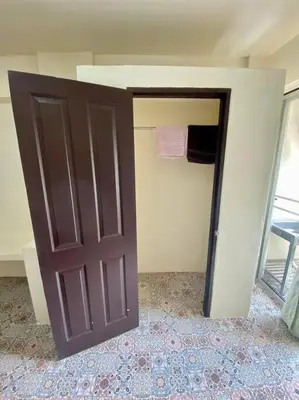 a closet with a brown door in a room at Ratanawong Place 807 in Bangkok