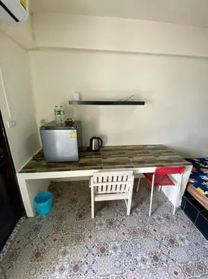 a kitchen with a table and chairs in a room at Ratanawong Place 807 in Bangkok