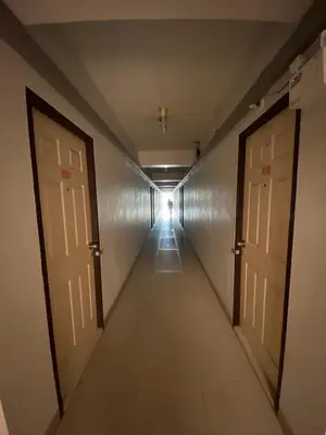 a long hallway with two doors and a hallwayngthngthngthngthngthngthngth at My Space 77 in Ban Khlong Khwang Klang