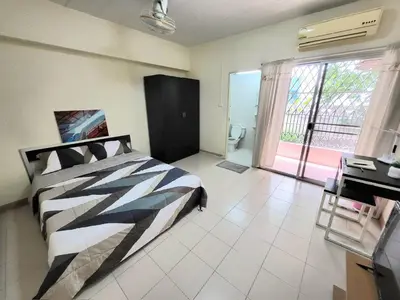 a bedroom with a bed and a bathroom with a window at My Space 77 in Ban Khlong Khwang Klang