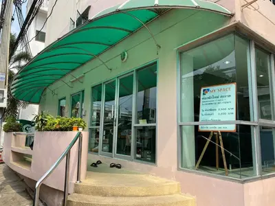 a store with a green awning and a sign in the window at My Space 77 in Ban Khlong Khwang Klang