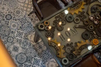 a close up of a clock with gears on a wall at House of Machine Boutique Hotel in Bangkok