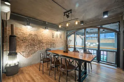 a dining room with a wooden table and chairs at House of Machine Boutique Hotel in Bangkok