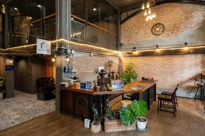 a room with a counter and a brick wall at House of Machine Boutique Hotel in Bangkok