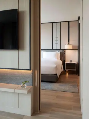 a hotel room with a bed and a television at dusitD2 Samyan Bangkok in Bangkok