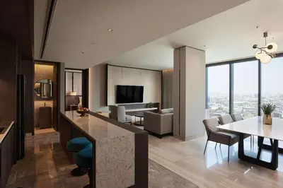 an open kitchen and living room with a view of a city at dusitD2 Samyan Bangkok in Bangkok