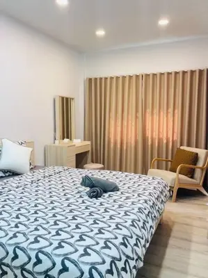 a bedroom with a blue and white bed and a chair at BKK Villa/Huaikwang China Twon in Bangkok