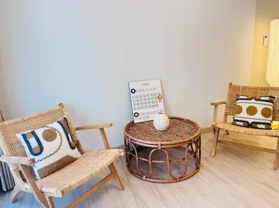 a room with chairs and a table with a sign on it at BKK Villa/Huaikwang China Twon in Bangkok