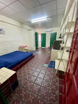 a room with a bed and a tiled floor at Ratanawong Place 206 in Bangkok
