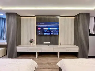 a bedroom with a large tv on a wall at DiscoveryHome at Pratunam market in Bangkok