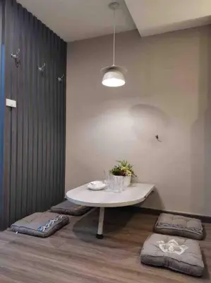 a room with a white table and some cushioned at DiscoveryHome at Pratunam market in Bangkok