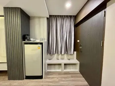 a room with a counter and a window with a refrigerator at DiscoveryHome at Pratunam market in Bangkok