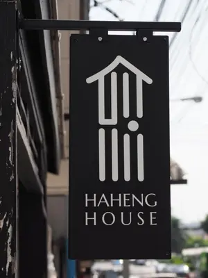 a sign for a hauling house hanging on a building at Haheng House in Bangkok