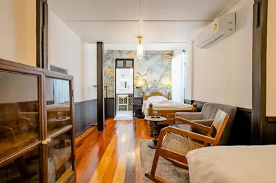 a hotel room with a bed and a living room at Haheng House in Bangkok