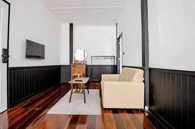 a living room with a couch and a table at Haheng House in Bangkok