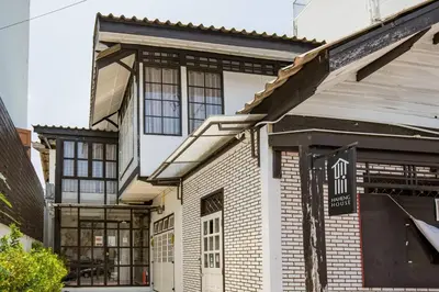 an old brick building with a sign in front of it at Haheng House in Bangkok