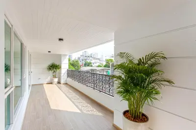 a balcony with a plant on the side of a building at GM Residence in Bangkok