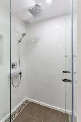 a shower in a bathroom with a glass door at GM Residence in Bangkok
