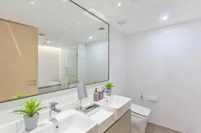 a bathroom with two sinks and a mirror at GM Residence in Bangkok