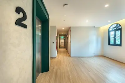 a hallway of a house with a number on the wall at Phra Nakhon Poshtel in Bangkok