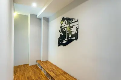 a room with a motorcycle hanging on the wall at Phra Nakhon Poshtel in Bangkok