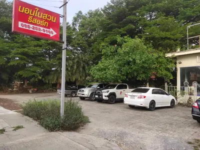 a bunch of cars parked in a parking lot at นอนในสวน รีสอร์ท in Bangkok