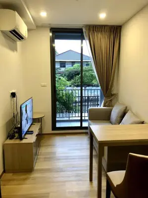 a living room with a couch and a television at NEST Sukhumvit71 BTS - Pool, Fitness, Parking, Wifi in Bangkok
