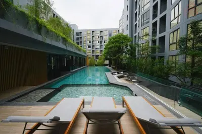 a swimming pool in the middle of a building at NEST Sukhumvit71 BTS - Pool, Fitness, Parking, Wifi in Bangkok