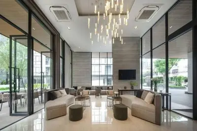 a living room with couches and a chandelier at NEST Sukhumvit71 BTS - Pool, Fitness, Parking, Wifi in Bangkok