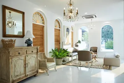 a living room with a table and chairs and a mirror at Arpo Pool Villa Riverside Bangkok in Bangkok