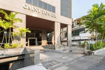 an office building with a sign that reads oral tower at SelfCheckIn Omni Tower Sukhumvit4 NaNa Asoke BTS MRT Hispeed WiFi Pool&Gym in Bangkok