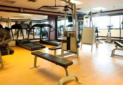 a gym with several treadmills and exercise machines at SelfCheckIn Omni Tower Sukhumvit4 NaNa Asoke BTS MRT Hispeed WiFi Pool&Gym in Bangkok
