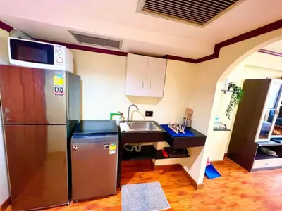 a kitchen with a refrigerator and a sink at SelfCheckIn Omni Tower Sukhumvit4 NaNa Asoke BTS MRT Hispeed WiFi Pool&Gym in Bangkok