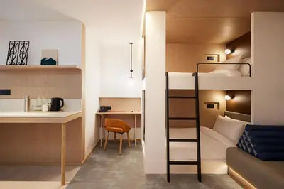 a small apartment with a bunk bed and a kitchen at ASAI Bangkok Sathorn in Bangkok