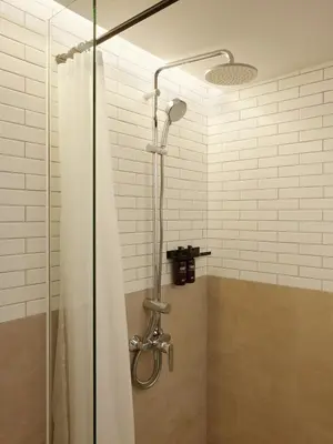 a shower with a shower curtain in a bathroom at ASAI Bangkok Sathorn in Bangkok