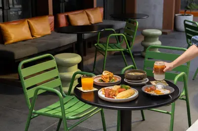 a table with plates of food and drinks on it at ASAI Bangkok Sathorn in Bangkok