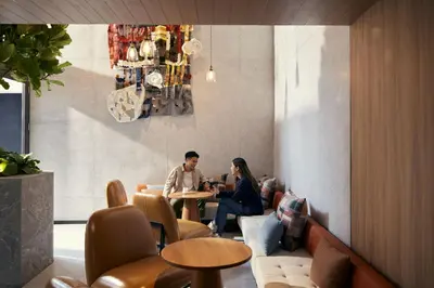 two people sitting at a table in a restaurant at ASAI Bangkok Sathorn in Bangkok