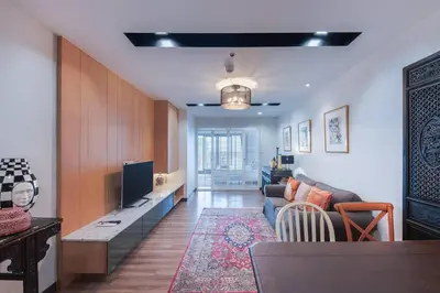 a living room with a couch and a tv at Central Bangkok, 5 stars river view & characteristic decor in Bangkok