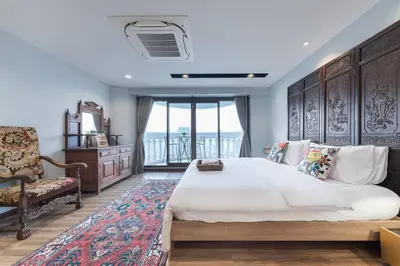 a bedroom with a large bed and a chair at Central Bangkok, 5 stars river view & characteristic decor in Bangkok