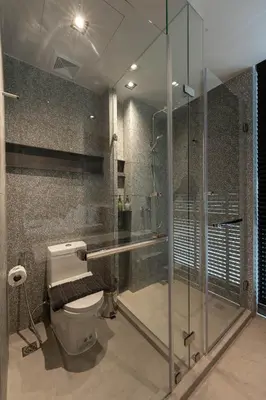 a bathroom with a toilet and a glass shower at EX2 Hotel in Ban Bang Khen (1)