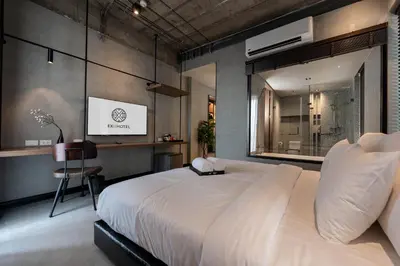 a bedroom with a large white bed and a desk at EX2 Hotel in Ban Bang Khen (1)