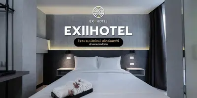 a bedroom with a bed with a sign on the wall at EX2 Hotel in Ban Bang Khen (1)