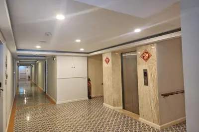a hallway in a building with a kitchen and a room at J PLACE HOTEL in Bangkok
