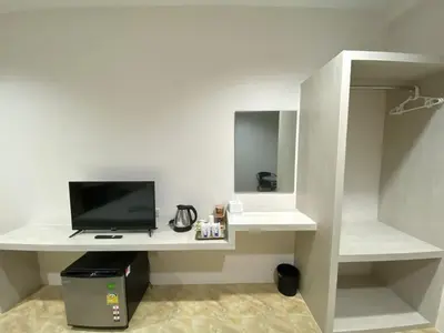 a room with a white desk with a television at บ้านสายสิริ in Ban Bang Talat