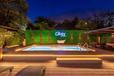 a swimming pool in front of a fence at Bangkok Cozy Garden Pool Villa Sukhumvit in Amphoe Phra Khanong