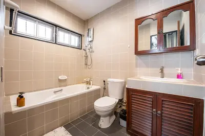 a bathroom with a toilet and a tub and a sink at Bangkok Cozy Garden Pool Villa Sukhumvit in Amphoe Phra Khanong