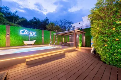a backyard with a swimming pool and a fence at Bangkok Cozy Garden Pool Villa Sukhumvit in Amphoe Phra Khanong