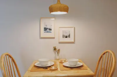 a wooden table with two bowls on top of it at Minimal Cozy Room near Chatuchak Weekend Market #2 in Bangkok