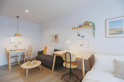 a living room with a couch and a table at Minimal Cozy Room near Chatuchak Weekend Market #2 in Bangkok
