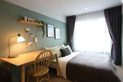 a bedroom with a desk and a bed and a desk and chair at WoodGreen Room near Chatuchak Weekend Market in Bangkok